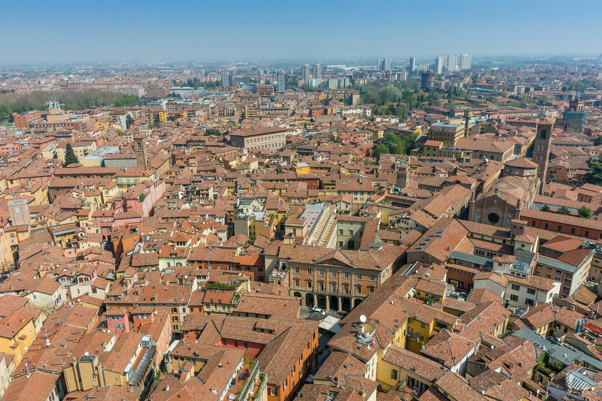 An aerial view of Bologna's historic rooftops stretching to the skyline