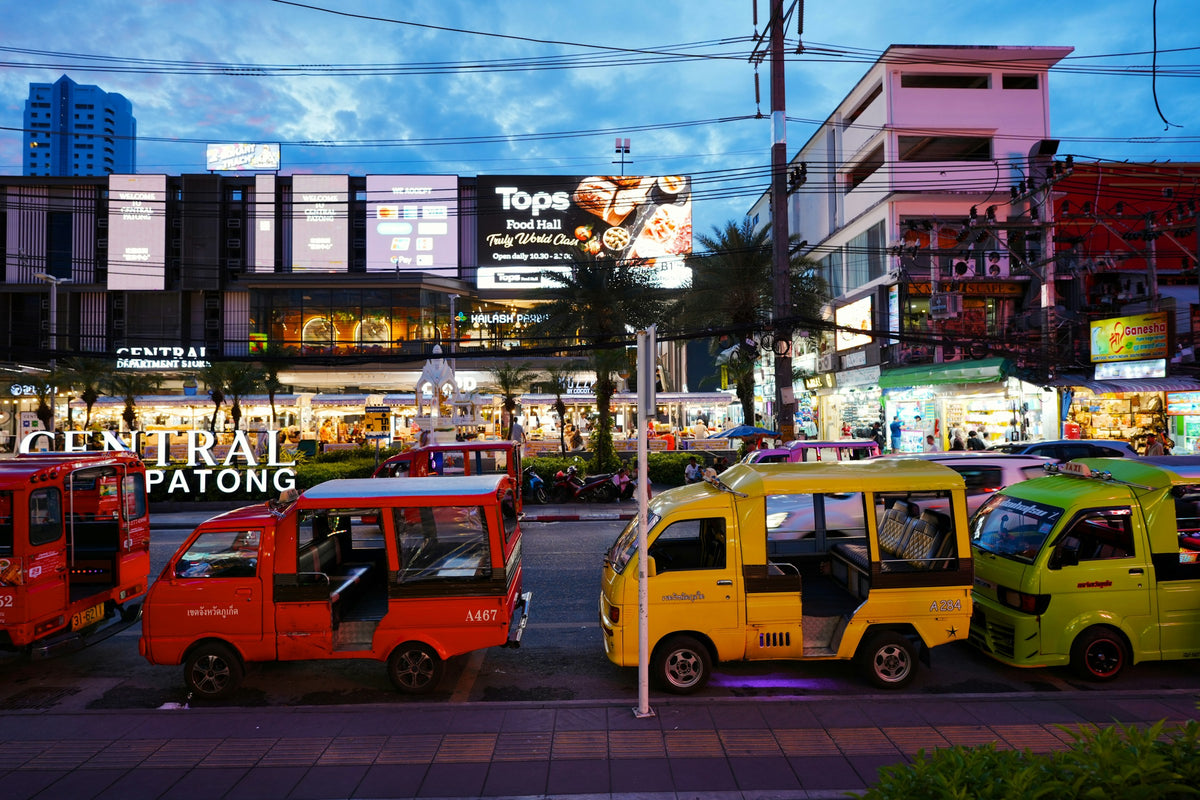 Tuk-tuks and songthaews waiting in front of Central Patong