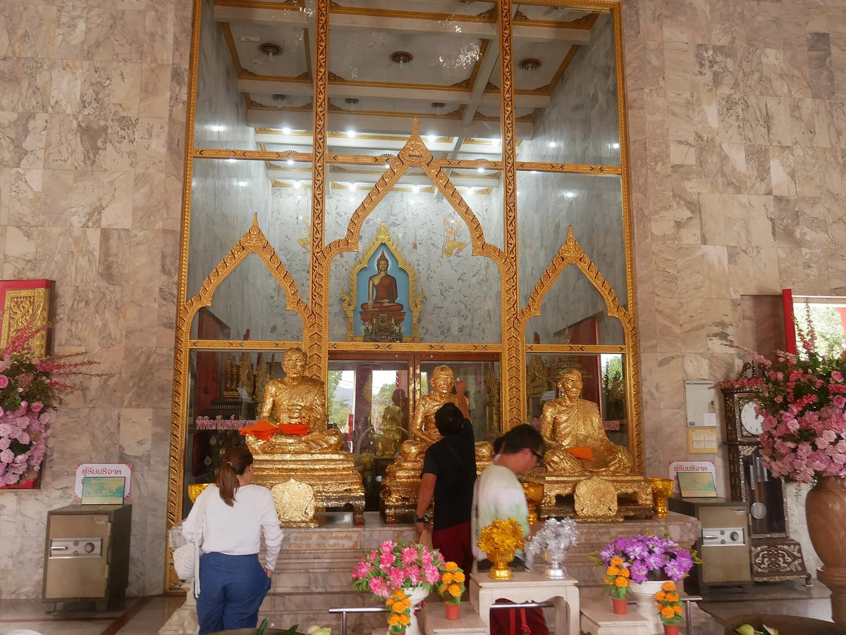 Buddha images and gilded decoration inside Wat Chalong
