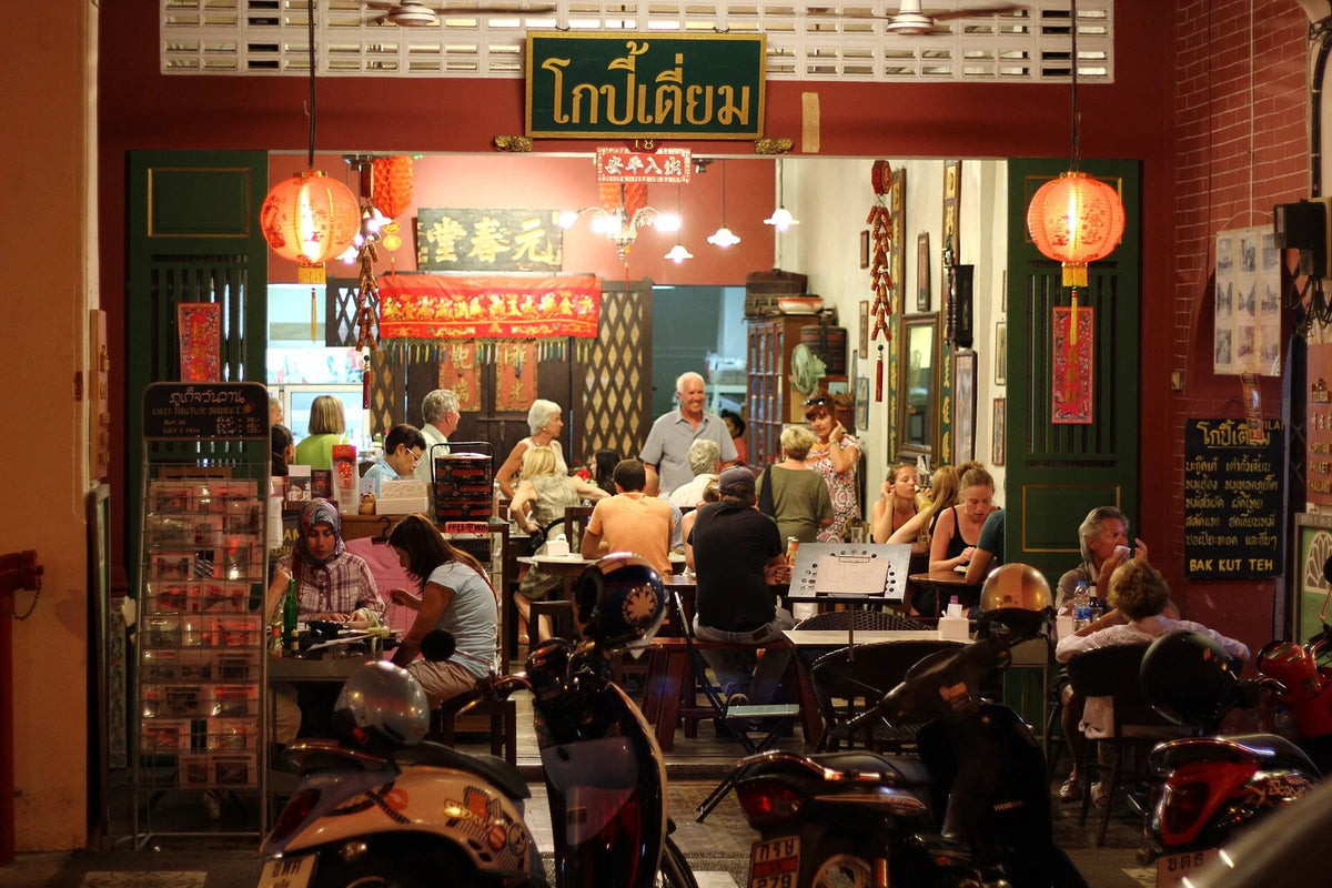 Diners inside the shophouse café Kopitiam by Wilai on Thalang Road