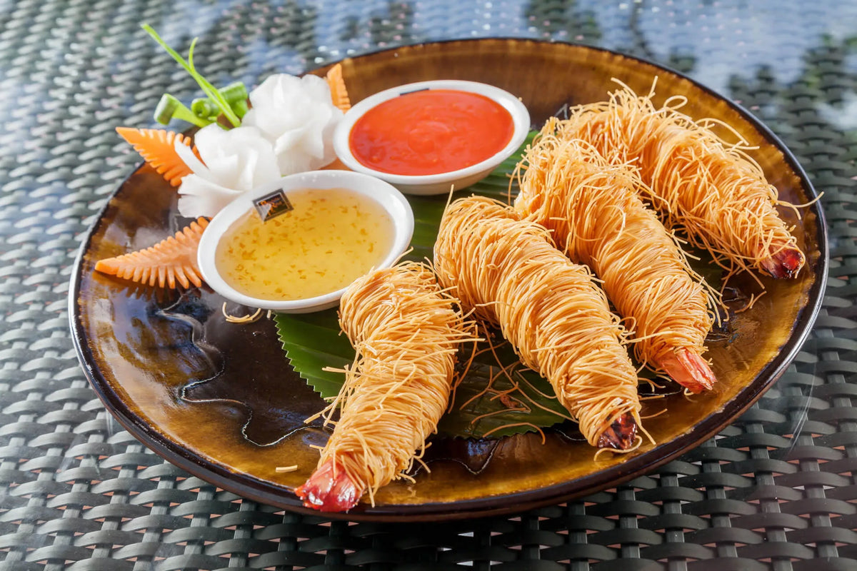Prawns wrapped in crispy noodles with dipping sauces at Baan Rim Pa