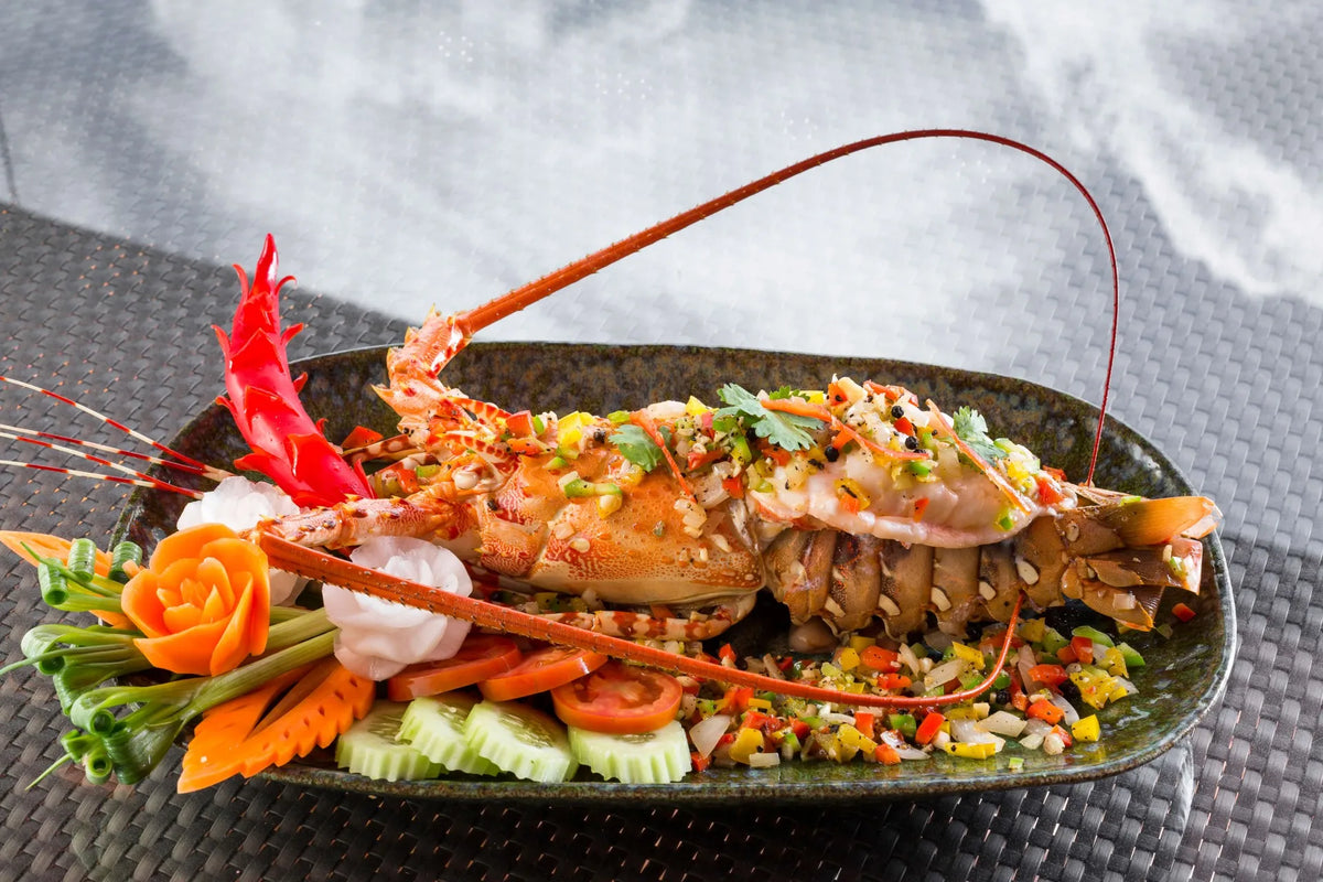 Whole lobster with Thai herbs and carved vegetable garnish at Baan Rim Pa