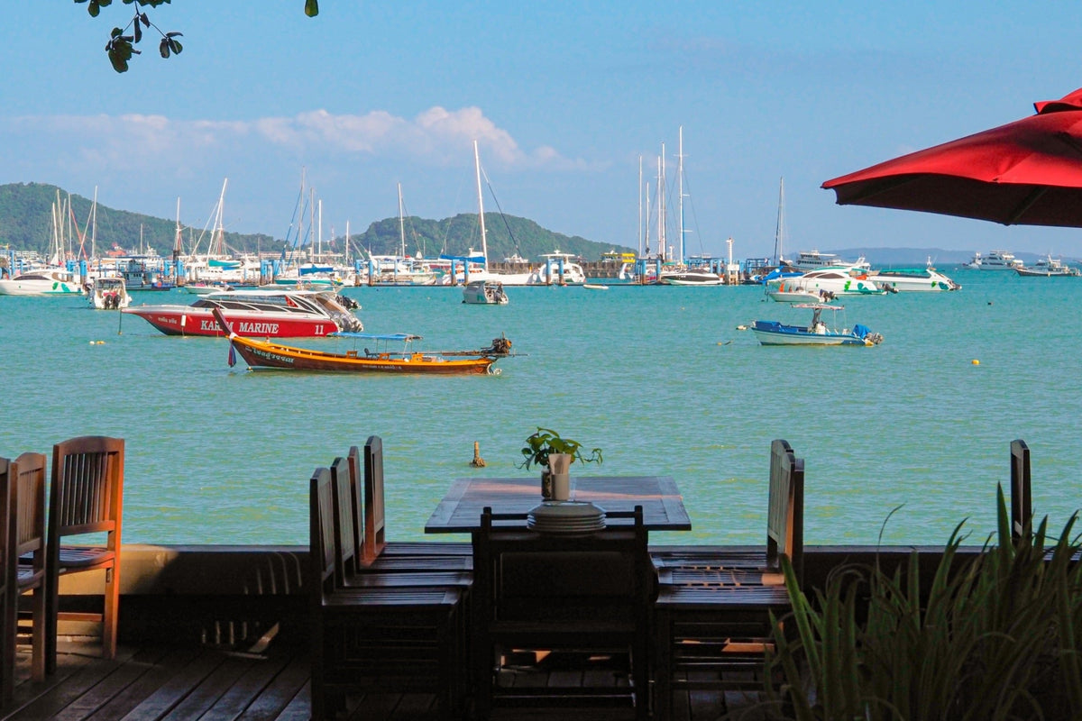 Waterfront tables overlooking boats in Chalong Bay at Kan Eang at Pier