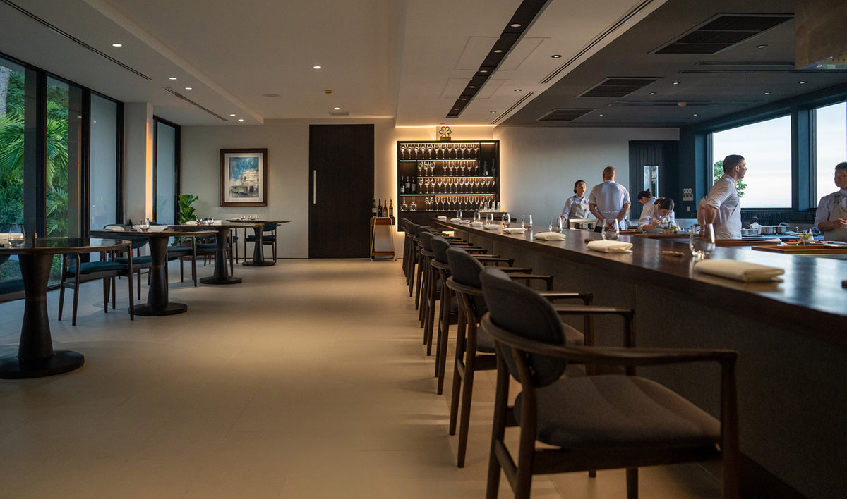 Dining room with long counter and sea-view windows at PRU