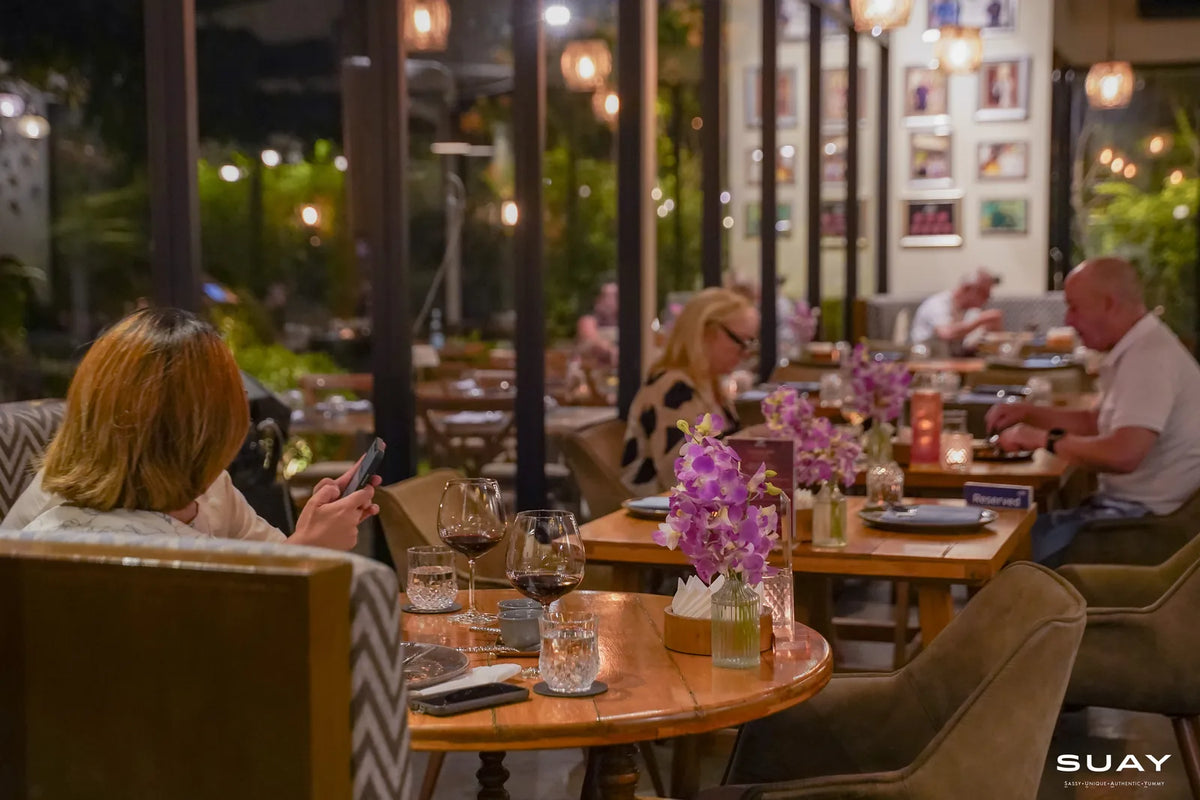 Dining room at full service with orchid centrepieces at SUAY Cherngtalay