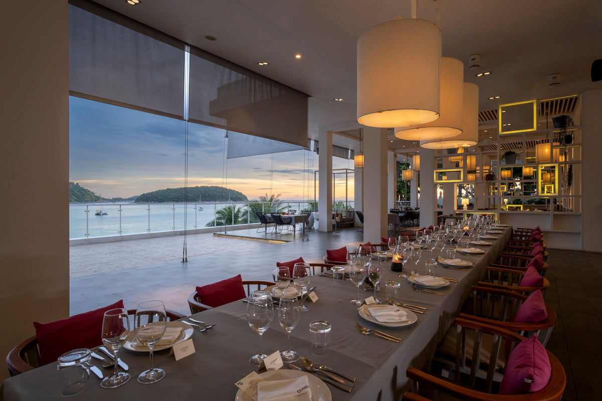 Cosmo Restaurant dining room overlooking the bay at The Nai Harn