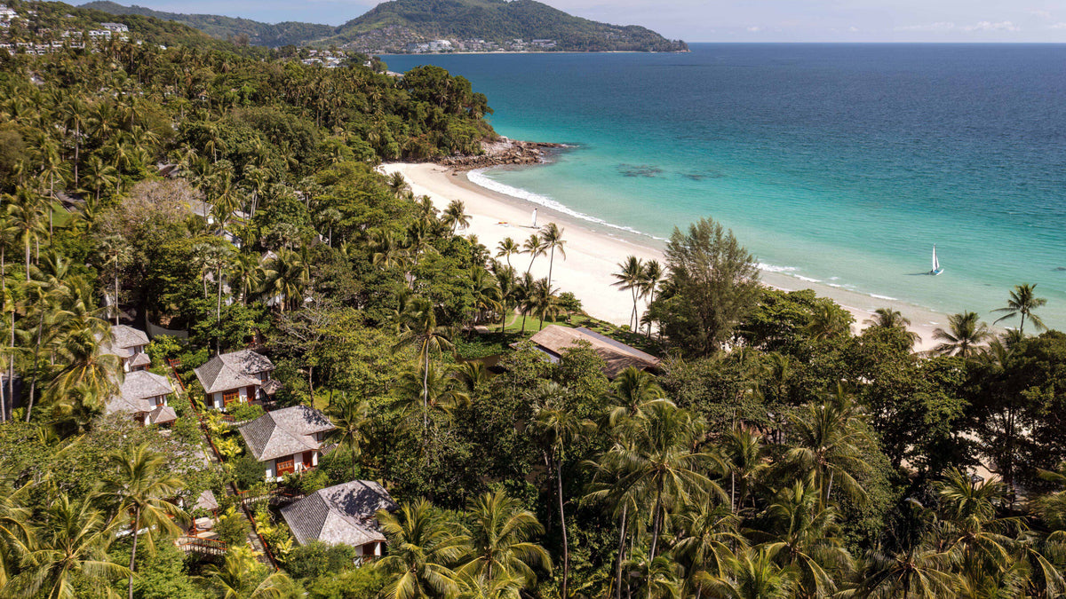 Cottages among palms above Pansea Beach at The Surin Phuket