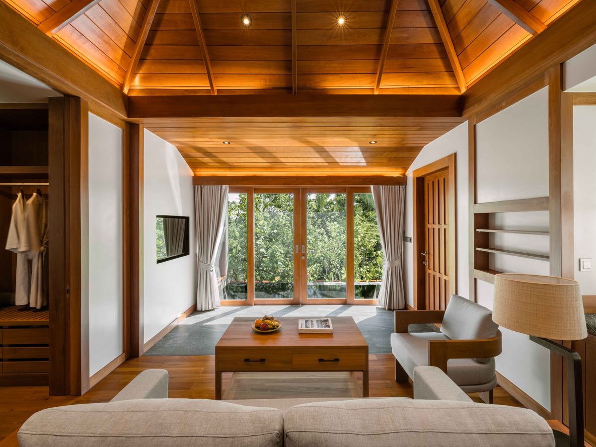Pool villa living room with timber ceiling at The Surin Phuket