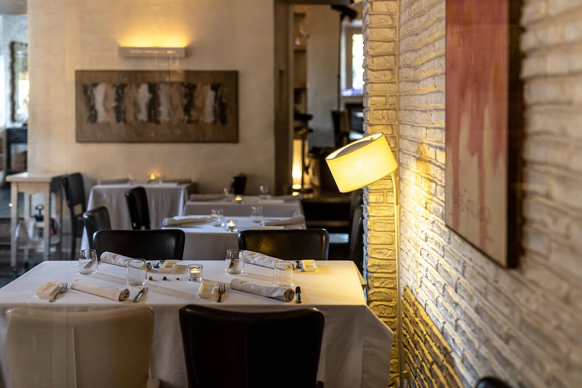 White-clothed tables in the dining room at Antico Arco