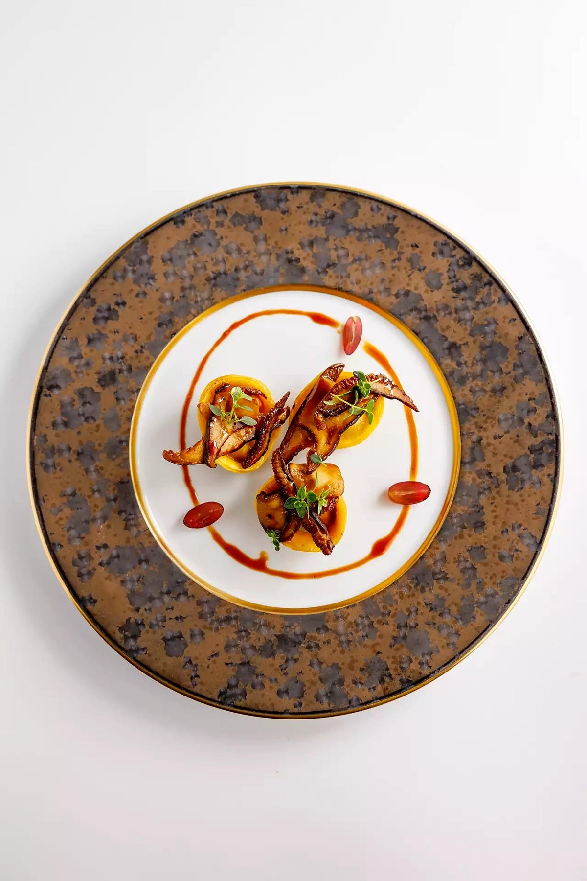 A plated pasta course with a glossy sauce at Antico Arco