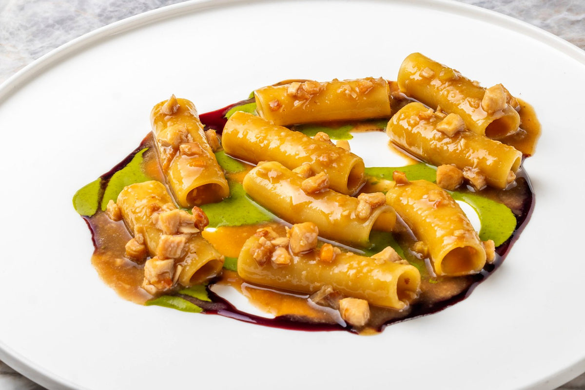 Paccheri in a glossy sauce on a herb purée at Aroma