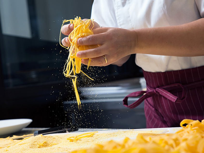 Freshly cut tagliatelle shaken out by hand at Colline Emiliane