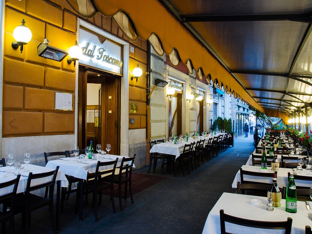 Tables laid beneath the portico at Dal Toscano