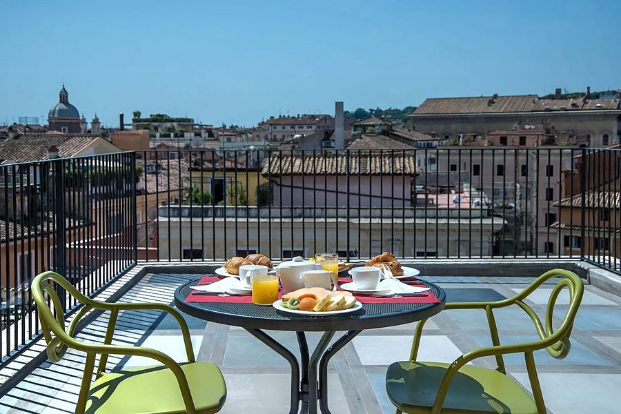 Breakfast on the rooftop terrace at Damaso Hotel, with domes on the skyline