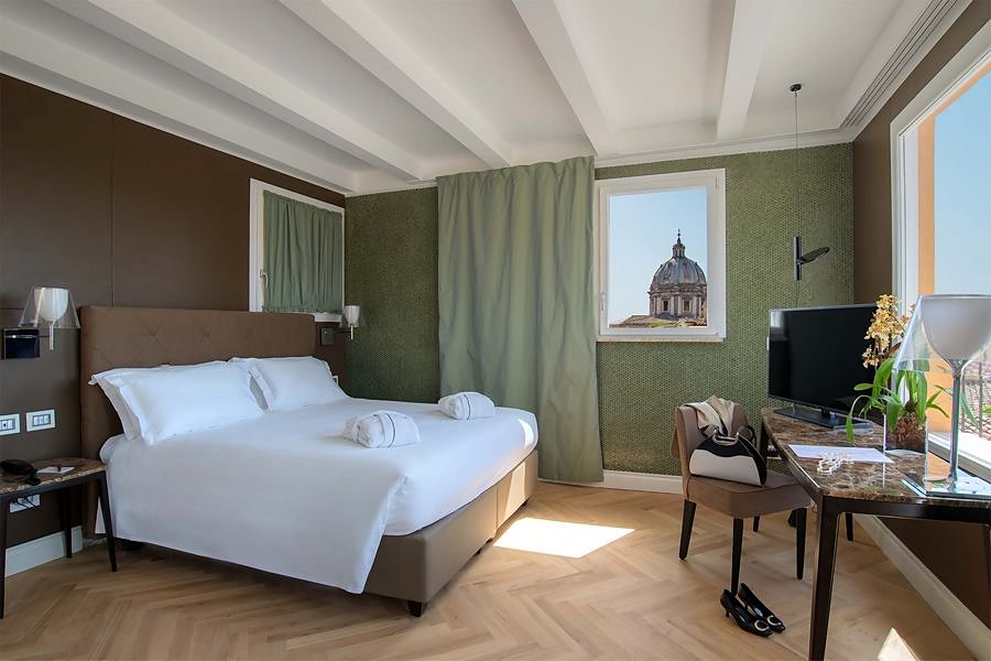 A room with a view of a church dome at Damaso Hotel