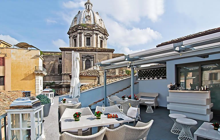 The rooftop terrace at Hotel Lunetta, beside a church dome