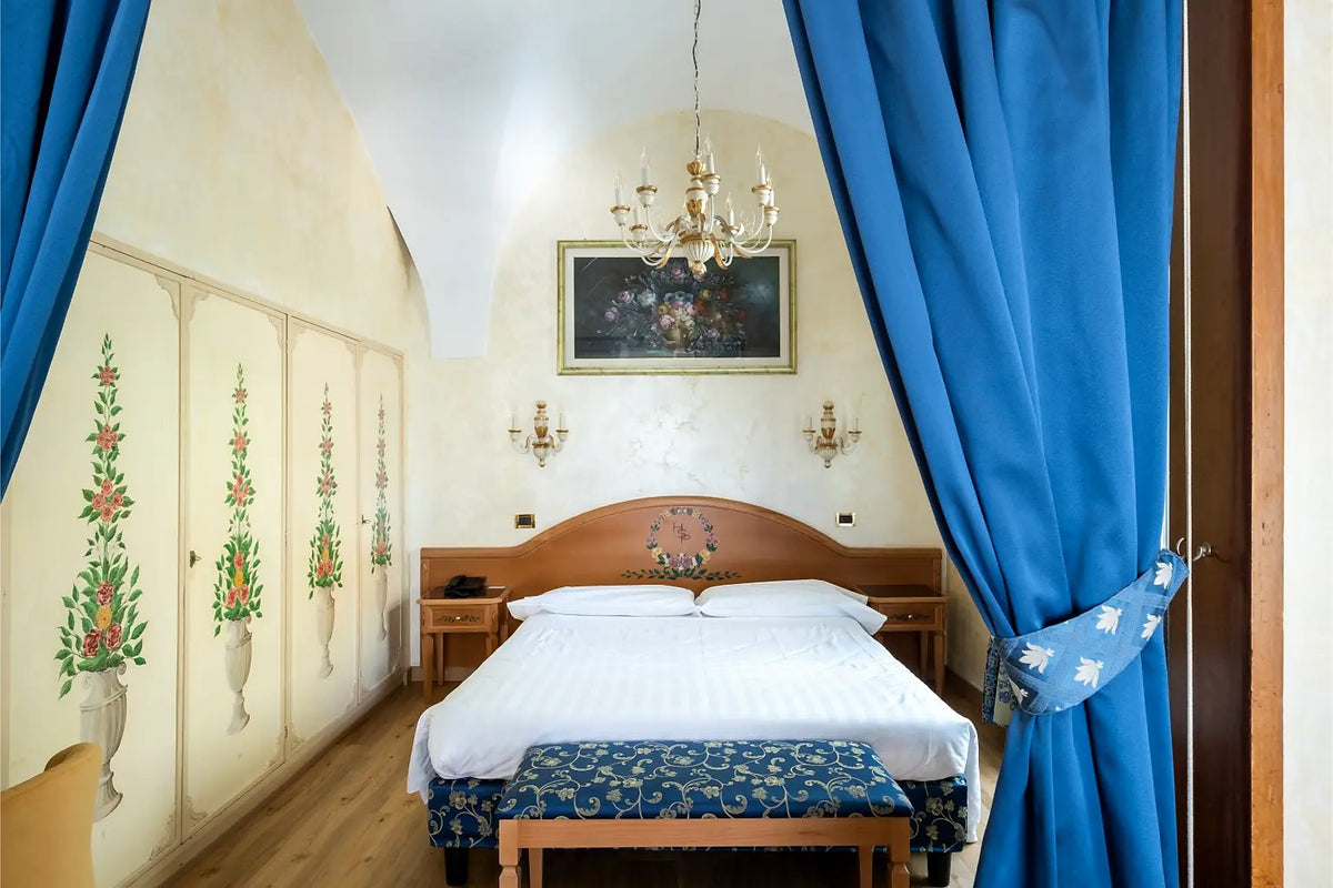 A junior suite with painted wardrobes at Hotel Santa Prisca
