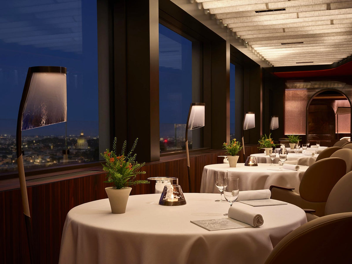 The dining room at La Pergola, with Rome beyond the windows