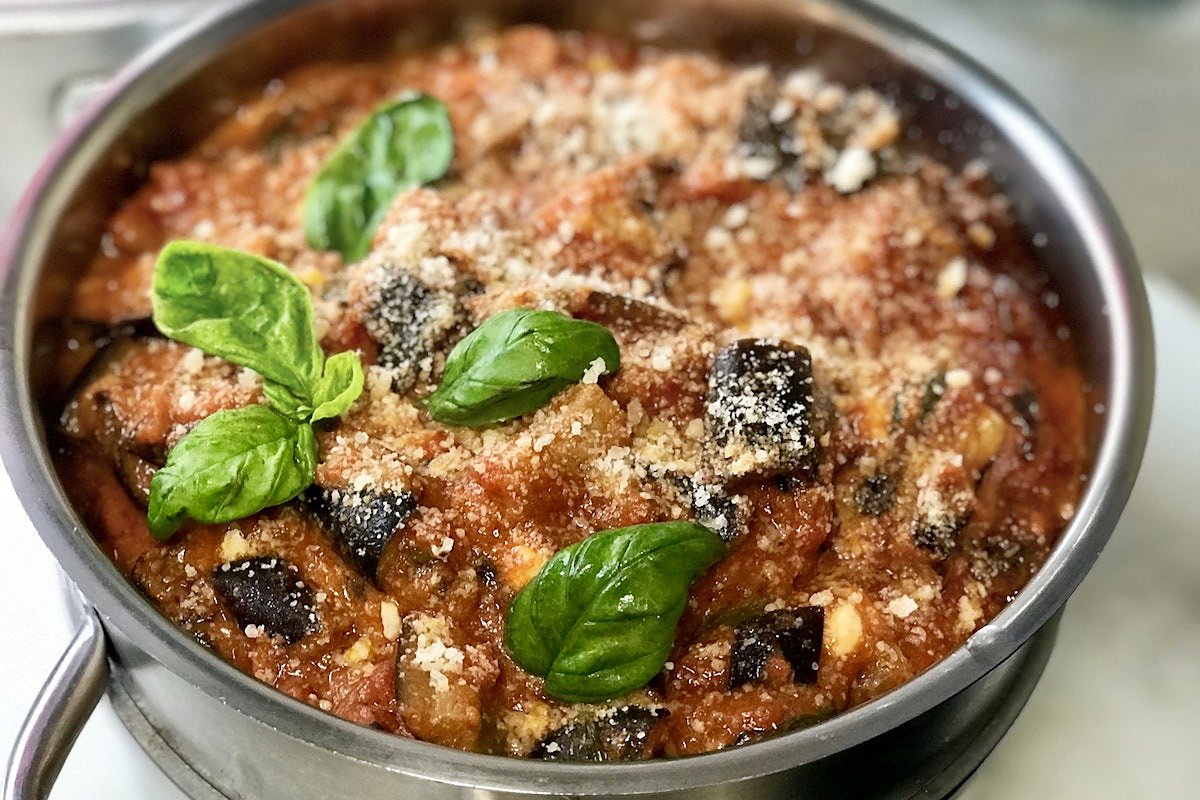 A pan of baked aubergine with basil at Trapizzino Testaccio