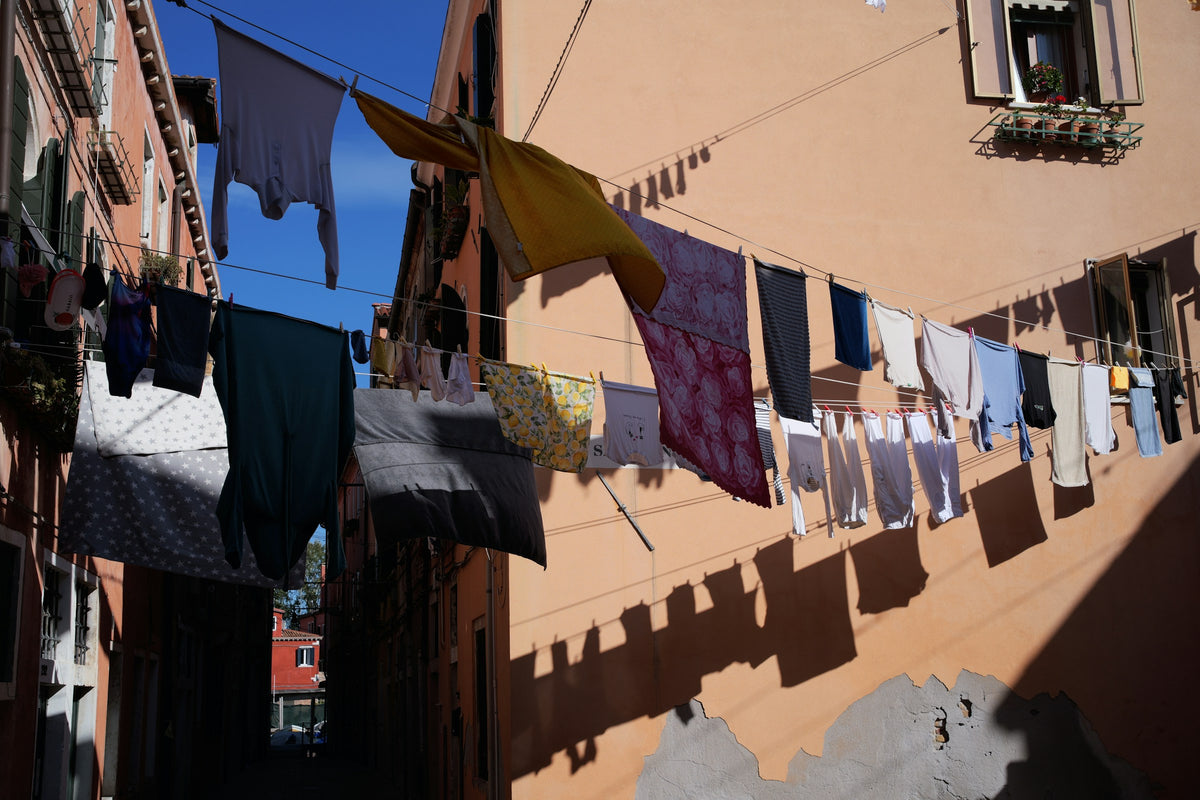 Laundry strung across a sunny calle in the Arsenale district