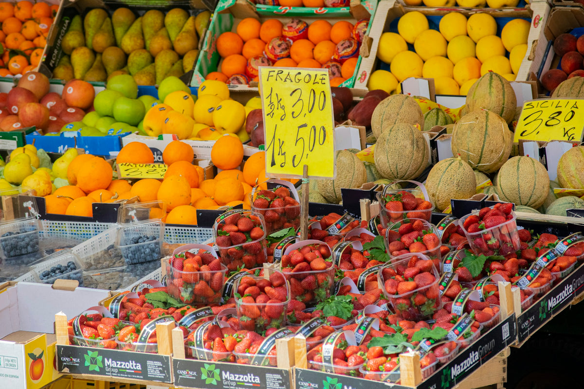 Strawberries, melons and citrus piled high at a Venice market stall