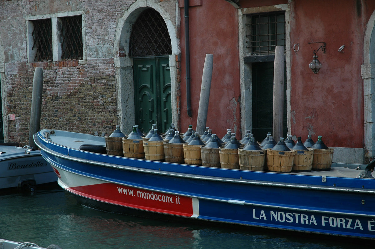Wine delivered by boat, with demijohns lined up on deck
