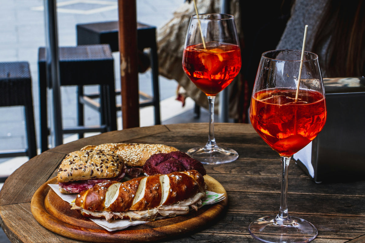 Two spritz and filled bread rolls served for aperitivo in Venice