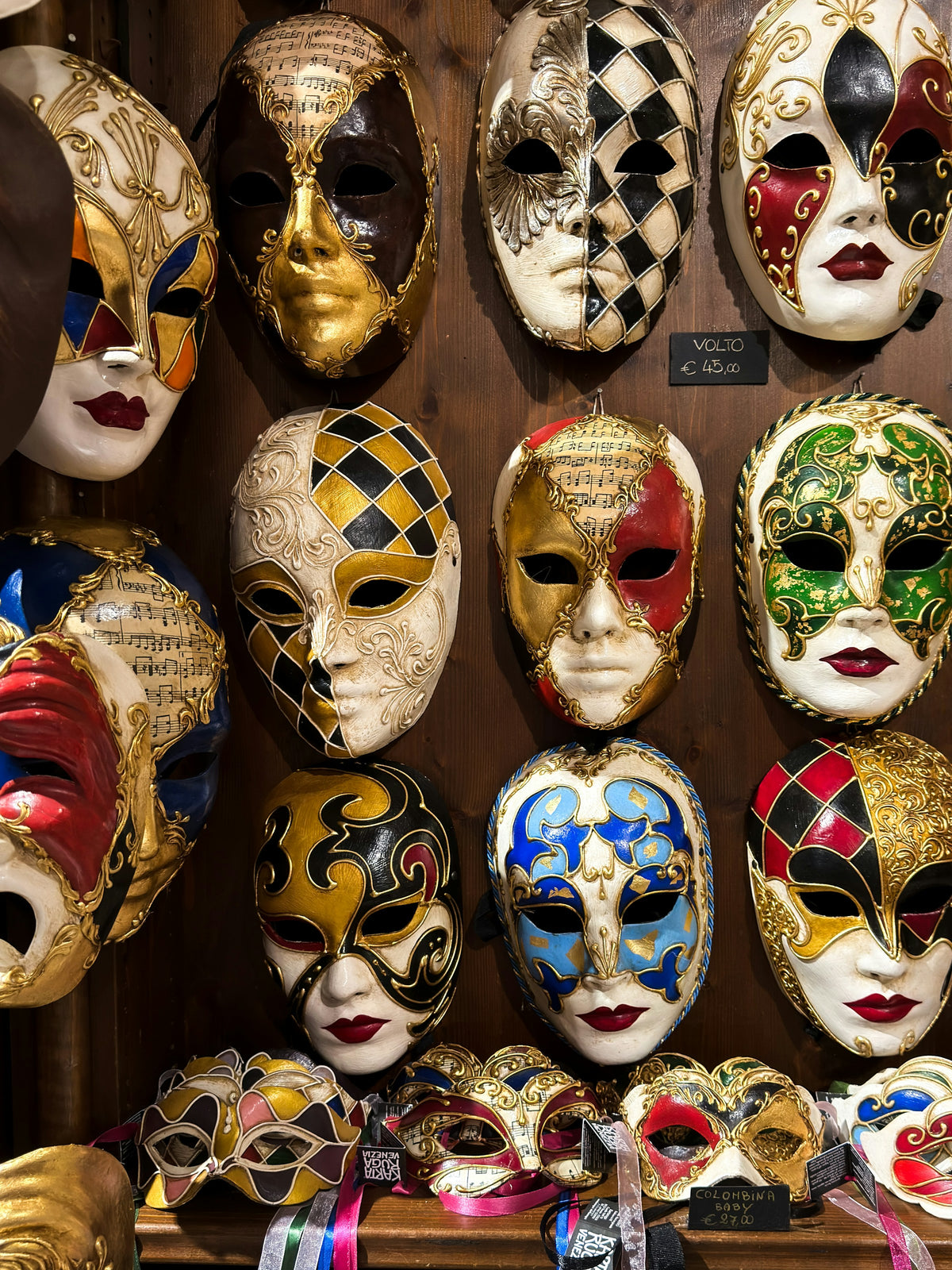 Hand-painted Venetian masks displayed on a shop wall
