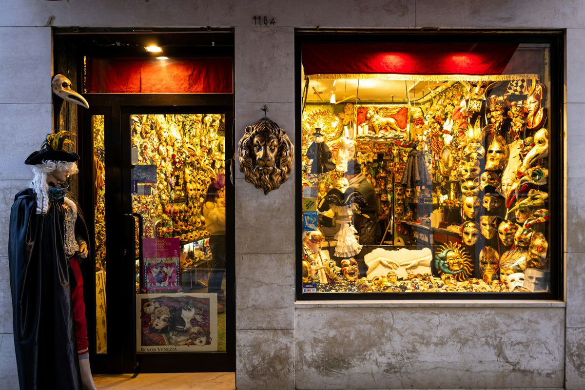 A shop window crowded with Carnival masks and costumes