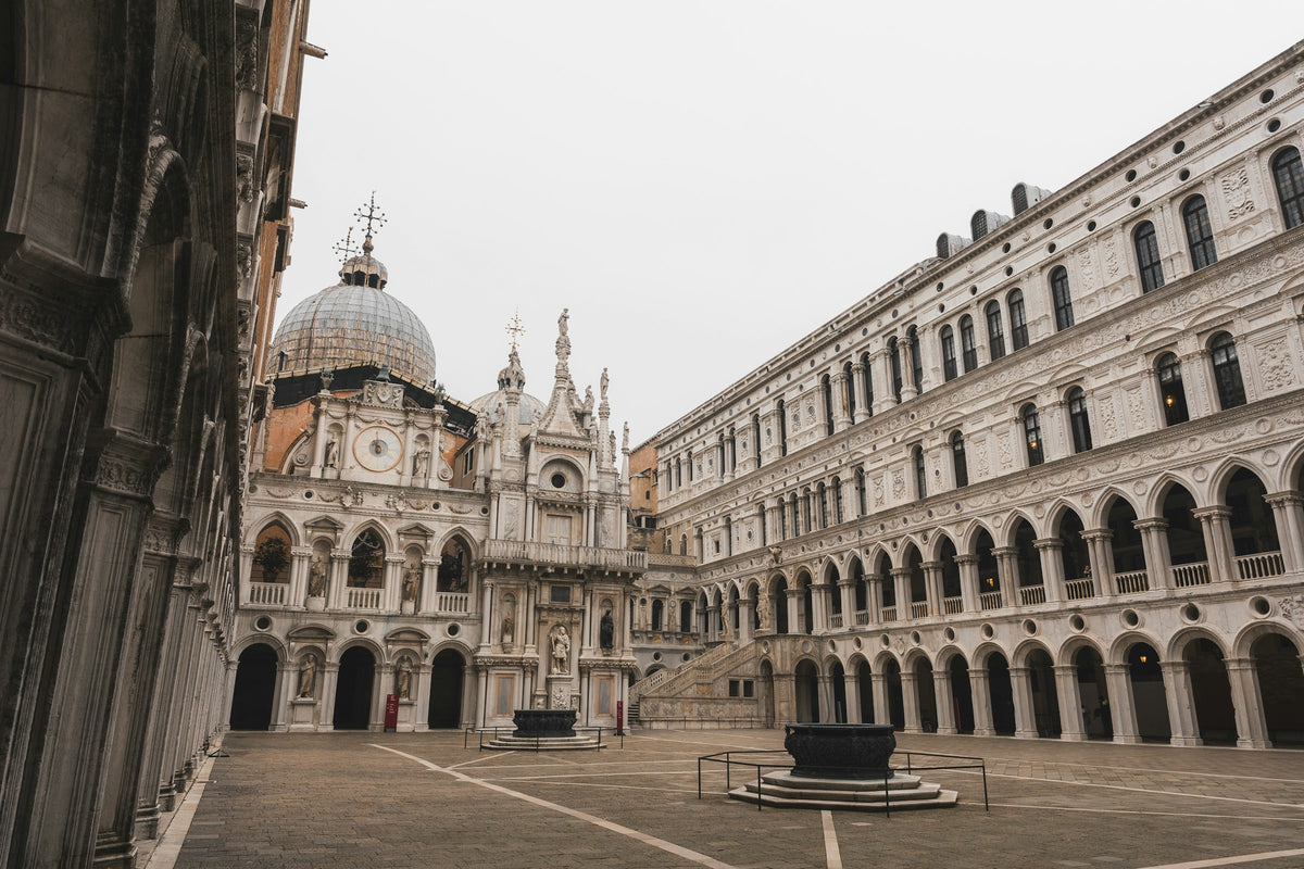 Inner courtyard of the Doge's Palace with its arcades and bronze wellheads