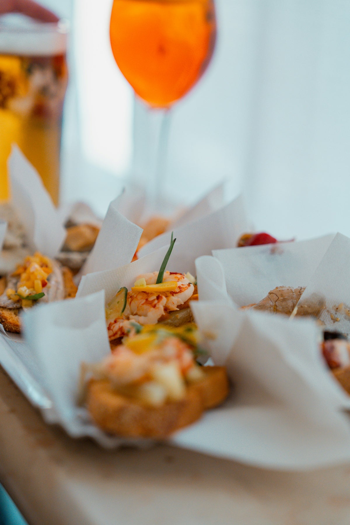 Prawn crostini served with an orange spritz