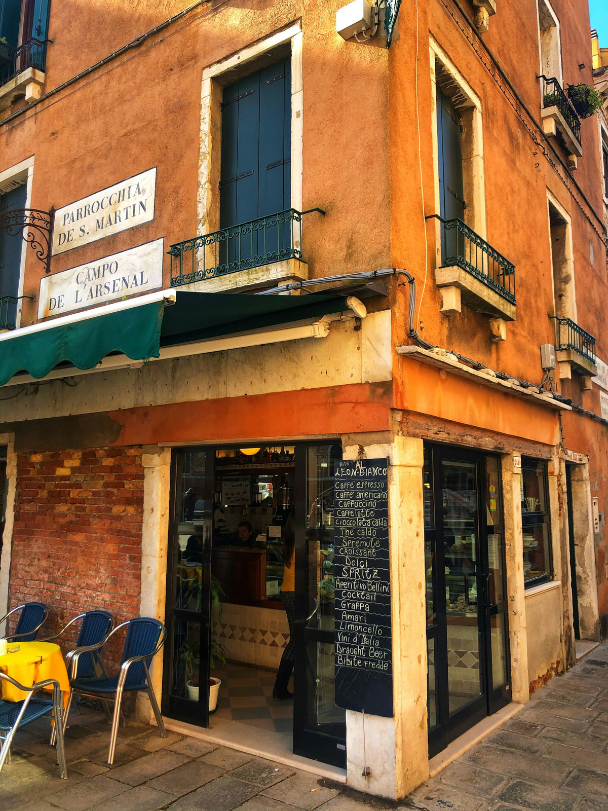 A corner bar on Campo de l'Arsenal with a chalkboard drinks list
