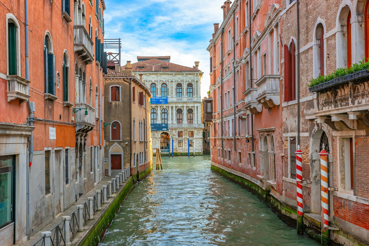 A side canal opening onto a palazzo across the Grand Canal