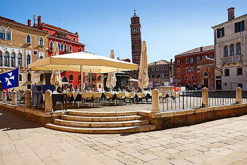 Restaurant terrace in Campo Sant'Angelo under a clear blue sky