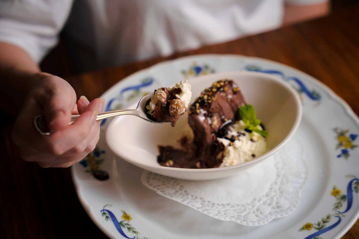 Chocolate dessert with cream in a hand-painted porcelain bowl
