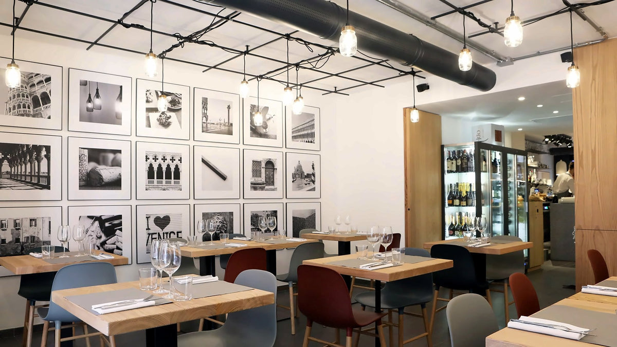 Modern dining room with black-and-white Venice photos and wooden tables