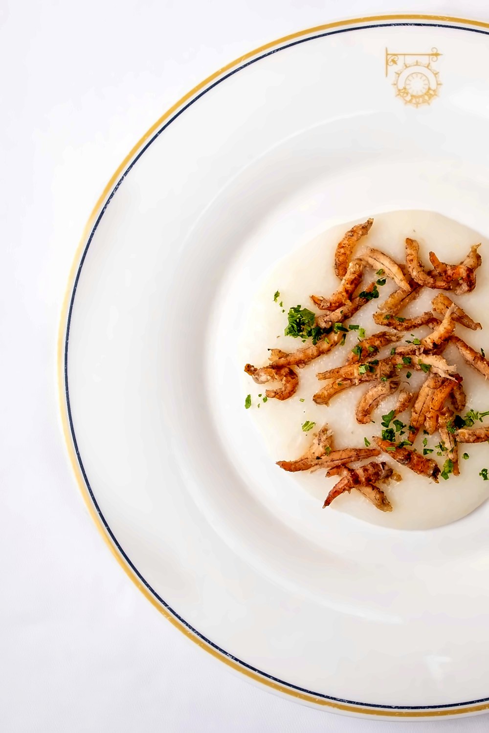 Creamy white polenta topped with fried small shrimp