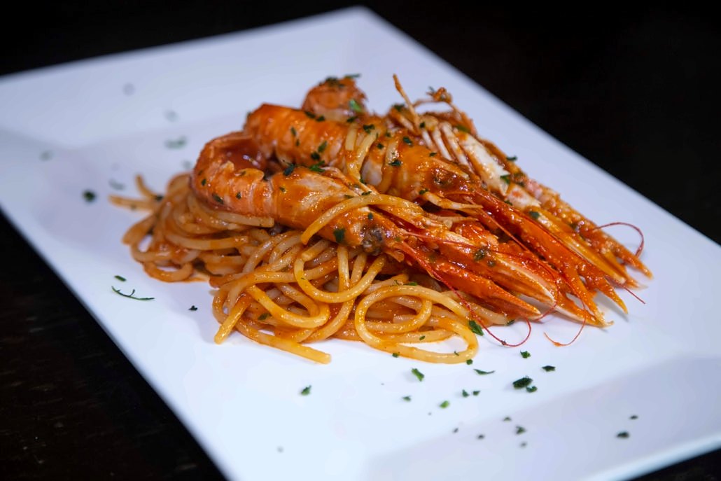 Spaghetti with langoustines in tomato sauce at Osteria da Alberto