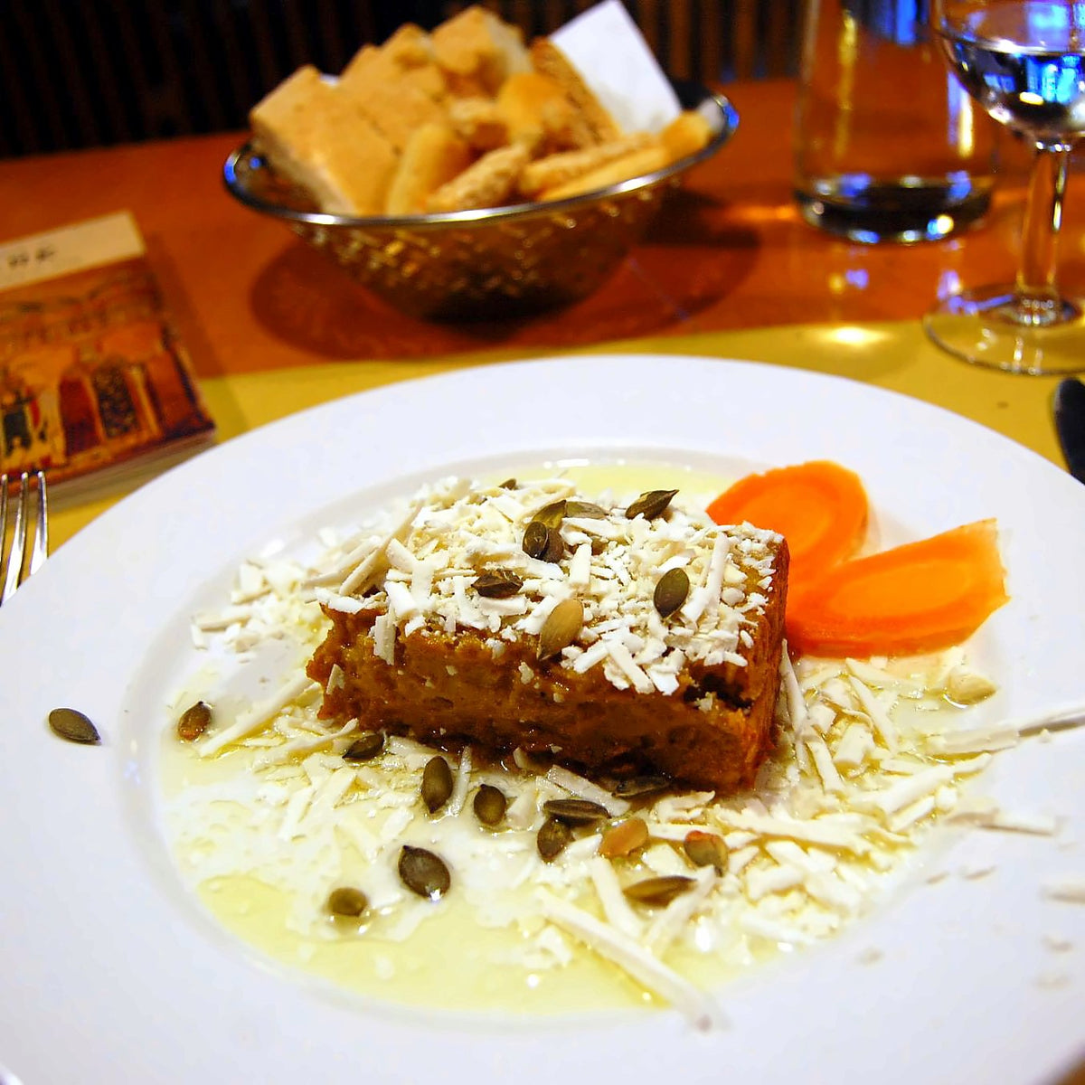 Pumpkin flan with pumpkin seeds and grated cheese at Osteria La Zucca