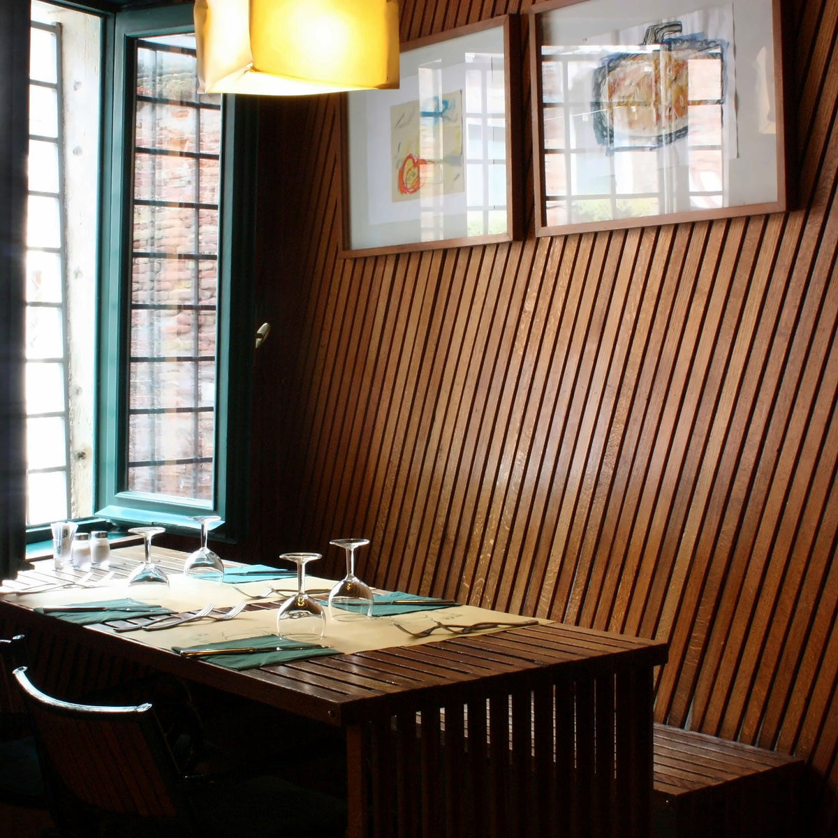 Wood-panelled corner table by the window at Osteria La Zucca
