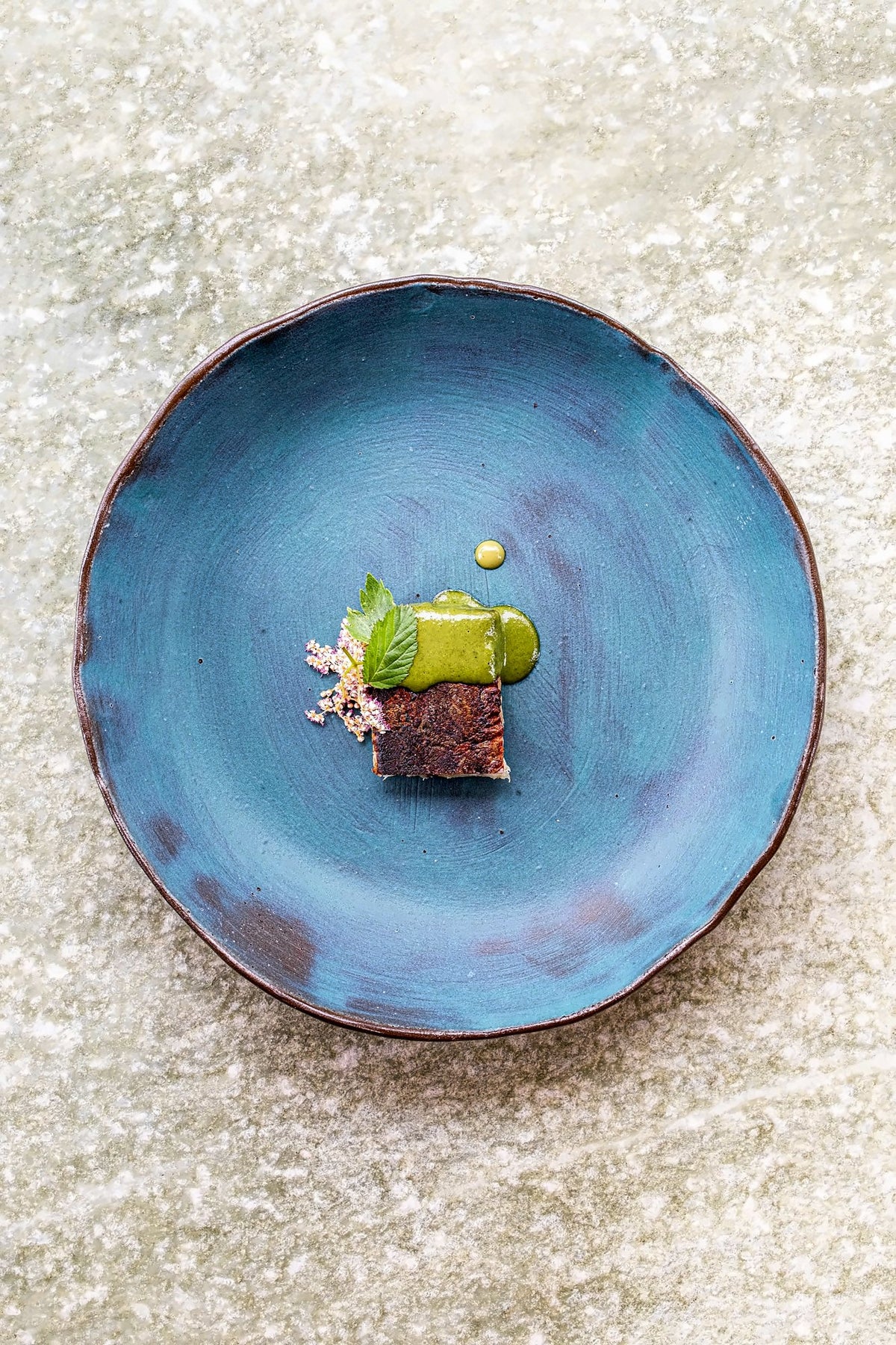 Small plated dish on a blue ceramic plate at Venissa