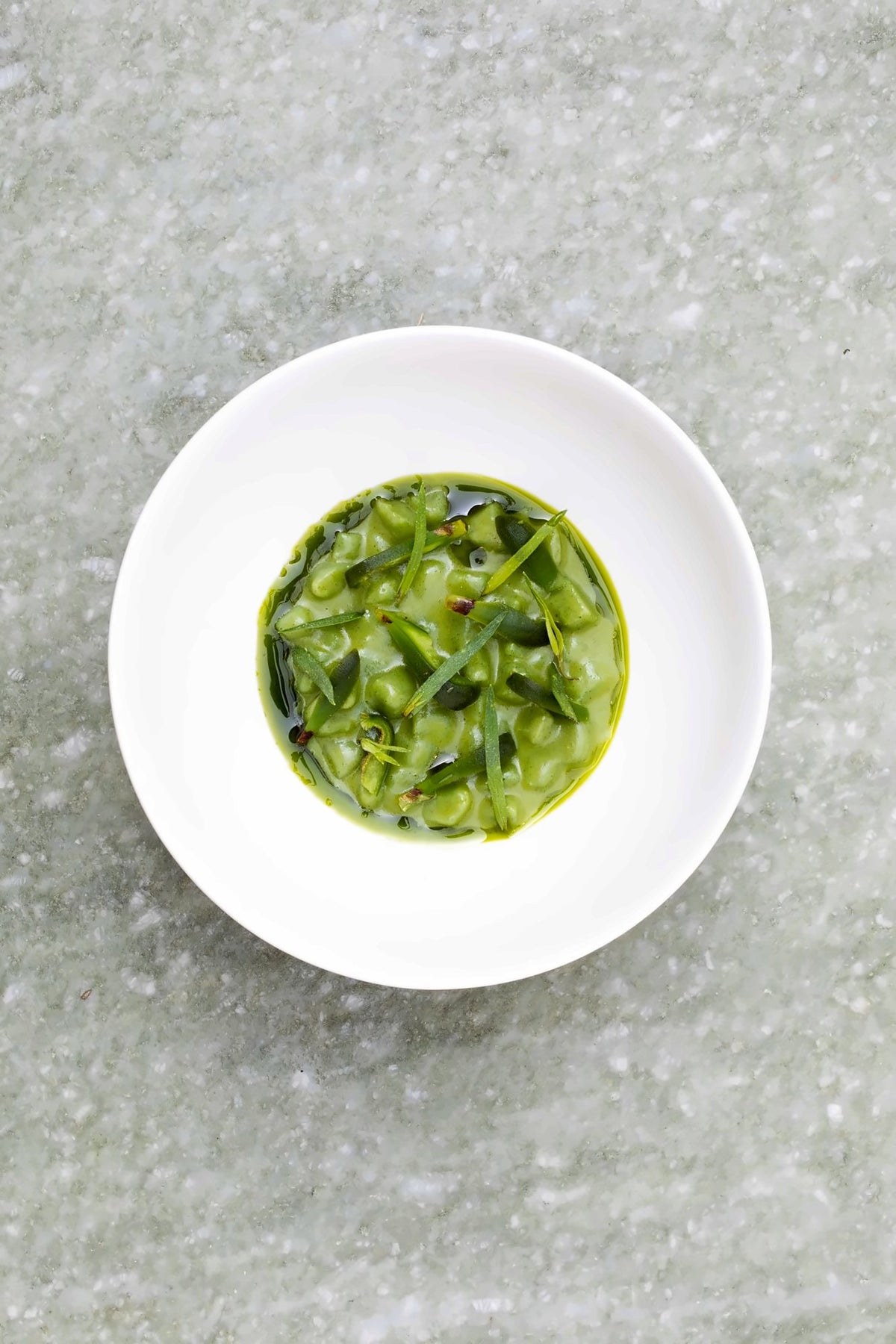 Green vegetable dish in a white bowl at Venissa