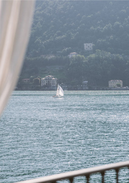 A sailing boat on the lake below Hotel Villa Flori